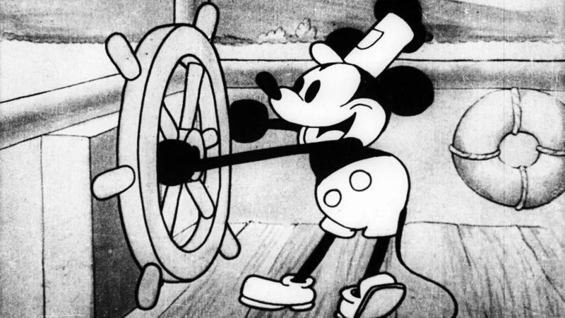 Mickey Mouse at the helm in Steamboat Willie (1928), one of the earliest sound-synchronized cartoons and a landmark of western animation.
