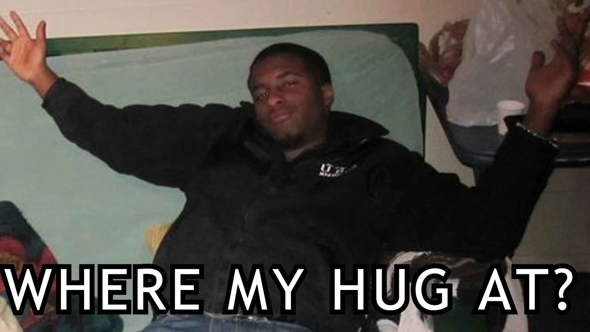 The definitive 'Where My Hug At?' cover image, featuring the original photo of a man with outstretched arms captioned with the iconic phrase.