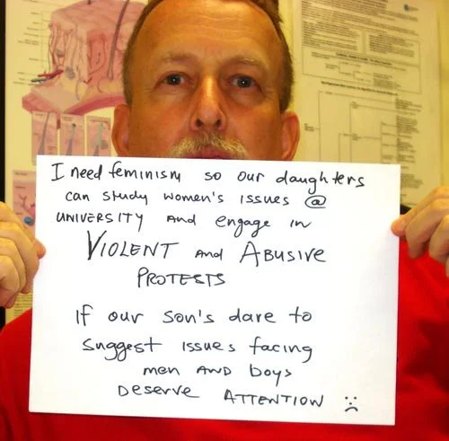 Sign critiquing dismissal of women's activism.