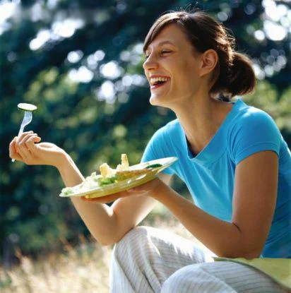 Archetypal women laughing with salad stock photo.