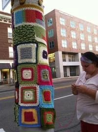 Pole covered in colorful granny square panels.