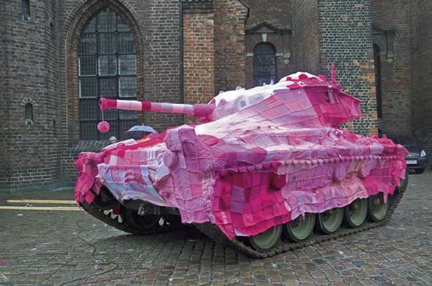 Pink yarn-bombed military tank.