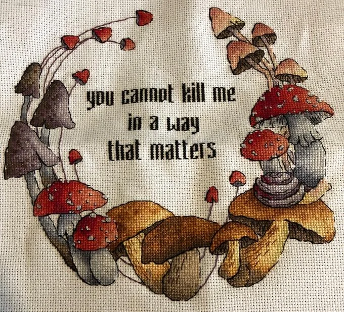Hand-embroidered textile fan art.